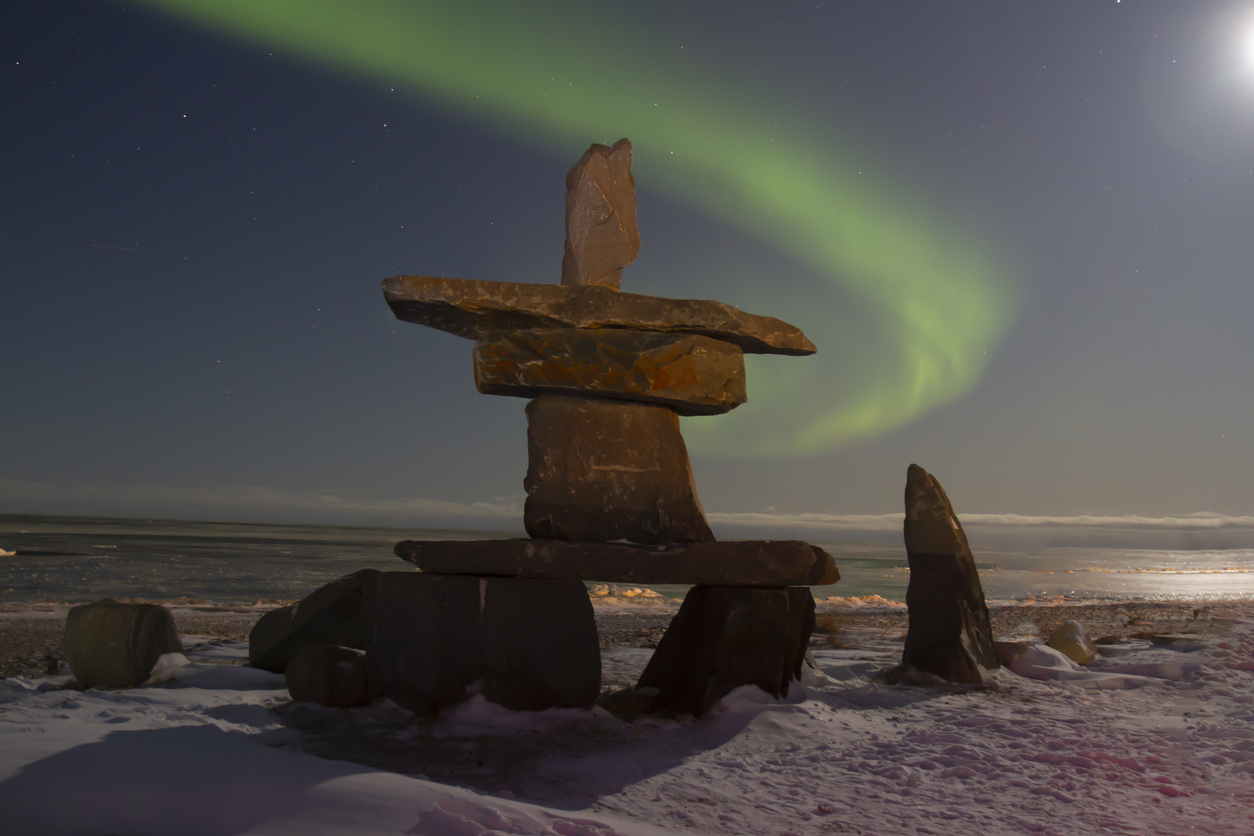 An inuksuk under the Northern Lights